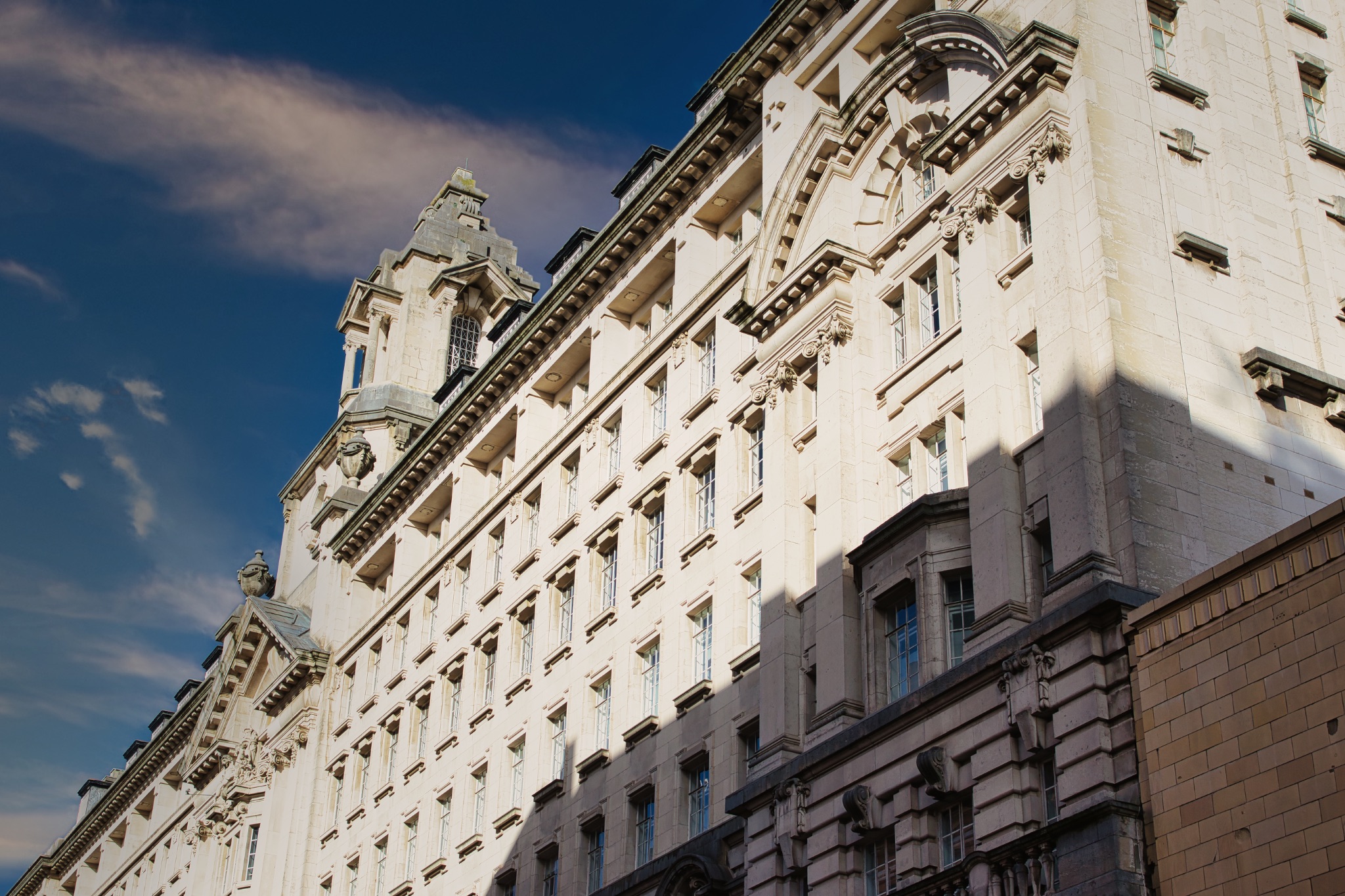 Facade of a Large Stone Building with Architectural Detailing in Manchester, UK.